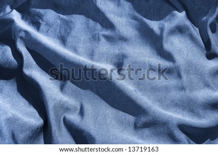 Creased blue, silky, cotton, satin fabric. For Christmas, bedroom, bed sheet, bed linen, bed cover, fashion, abstract, interior, textile background design. More textiles and background in my port.
