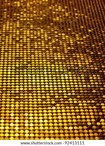 Sparkling, metallic, golden, sequined textile for disco, party or fashion designs.