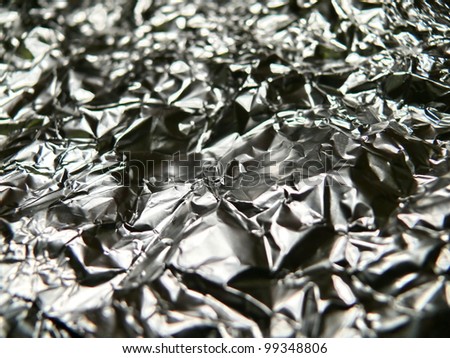 Metallic, crumpled, metallic, aluminum texture close up. Good for kitchen, abstract, industrial, ecology or conceptual designs.