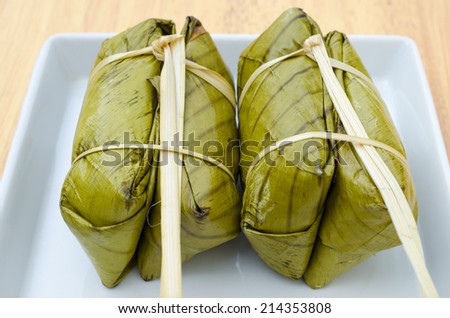 KHAO TOM MAD, Thai traditional dessert, steamed sticky rice in banana leaf packaging