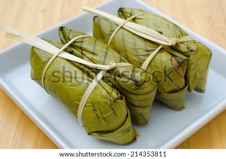KHAO TOM MAD, Thai traditional dessert, steamed sticky rice in banana leaf packaging