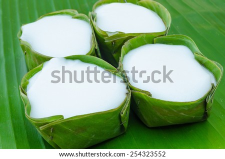 Pudding with coconut-milk topping, Traditional Thailand dessert wrapped with banana leaves.