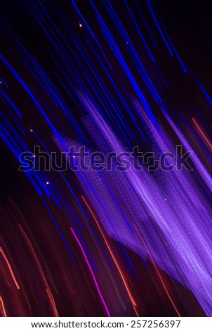 Abstract city night light of christmas tree on dark background. Moving the camera