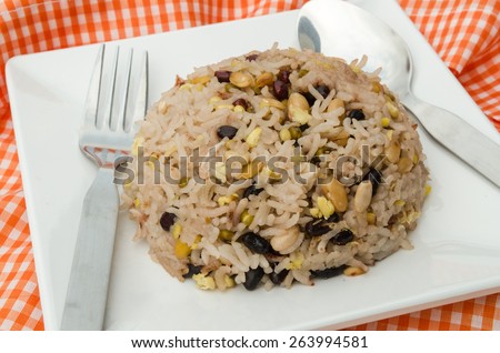 Mixed rice, beans, black bean red beans tenykhry pearl barley or adlay and grain on white dish.