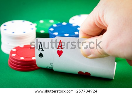 Player looking down at a pocket pair of aces in Texas Hold\'em poker game