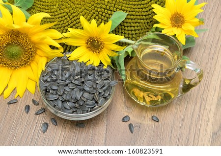 seeds and sunflower oil, sunflower flowers close-up. top view Ã?Â¢?? horizontal photo