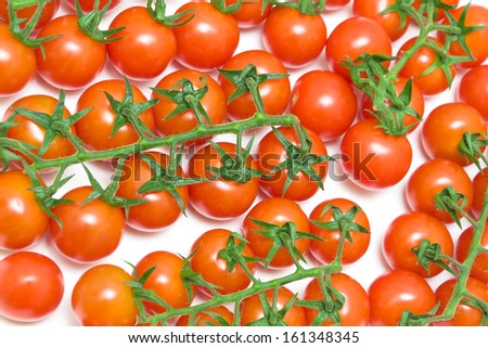 ripe cherry tomatoes closeup on a white background. top view - horizontal photo.