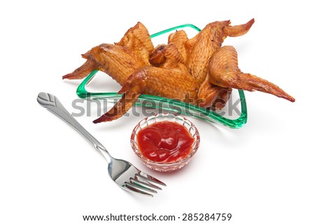delicious smoked chicken wings and ketchup on a white background. Horizontal photo.