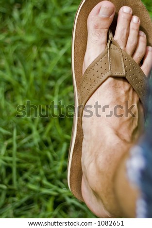 males foot wearing sandals