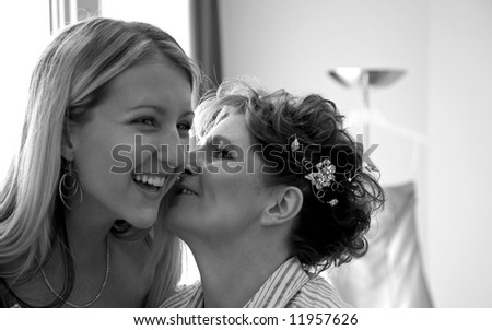 mother and daughter kissing before the wedding.