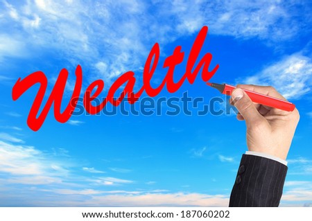 Hand writing word Wealth over blue sky background