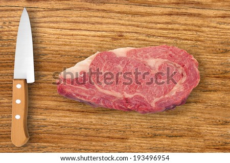 knife and meat on cutting board isolated on white background