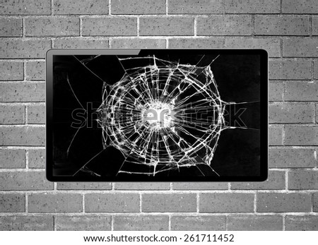 Blank screen LCD tv with broken screen hanging on a wall