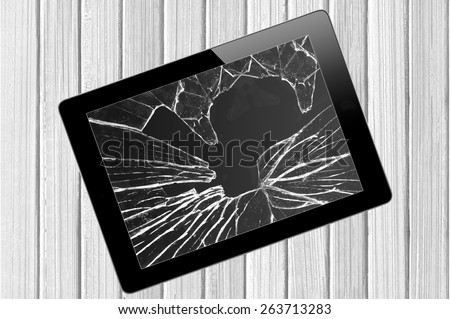 Black Touch Screen Tablet with broken screen over wooden background