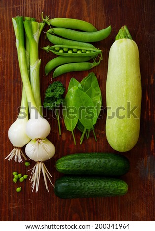 Fresh green vegetables and herbs on a dark background. Vegetable concept.