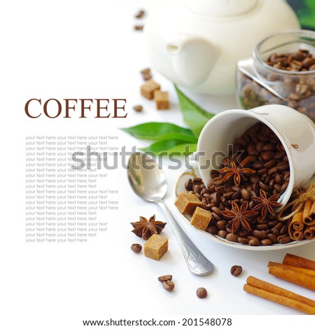 aromatic coffee beans and spices (star anise and cinnamon). isolated on white background. British tableware.