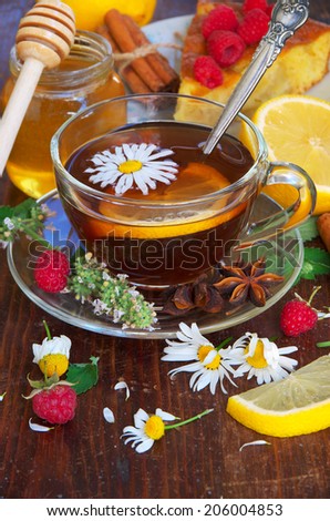 Herbal tea with chamomile flowers and Lemon. Berries and honey.