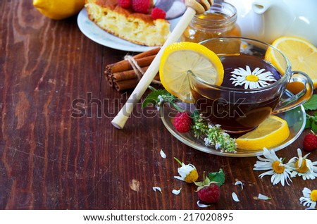 Healthy Breakfast. English tea with lemon.  Herbal tea and honey on wooden background