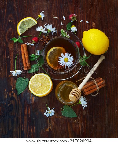 English tea with lemon. Herbal tea and honey on wooden background. Health and diet concept