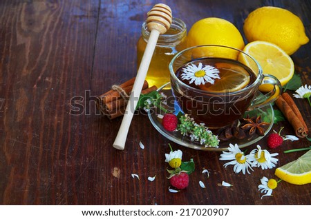Healthy Breakfast. English tea with lemon. Herbal tea and honey on wooden background