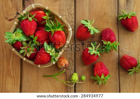Ripe strawberries. Top view. Old wooden table.  Harvest berries