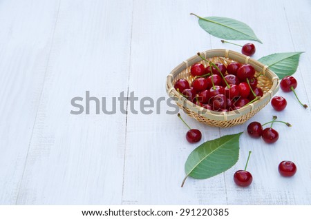 Ripe cherries on an old wooden table. Harvest berries. space for text. white wooden table