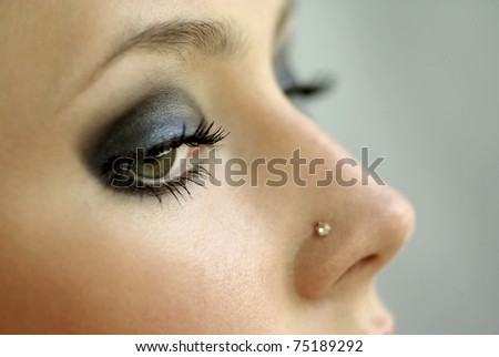 Modern fashion blue makeup of a female eye . Beautiful woman eyes