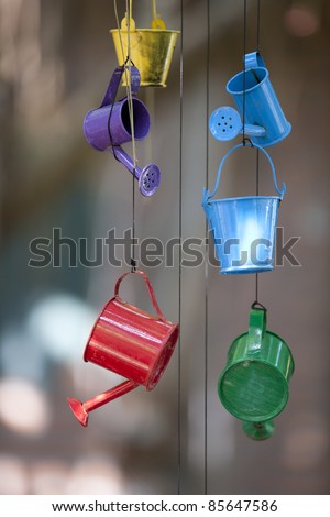 Colorful Toy of Pail and Watering Can hanging on the ceiling.