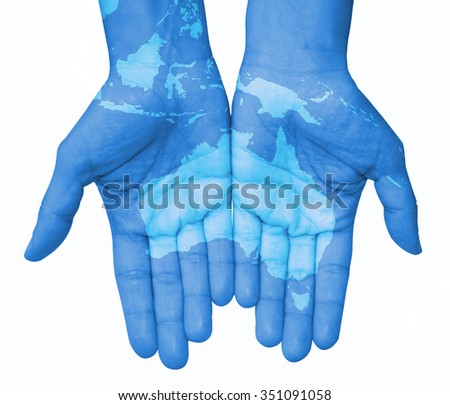 Hands with Australia and Indonesia, Australia map drawn. The world in your hand