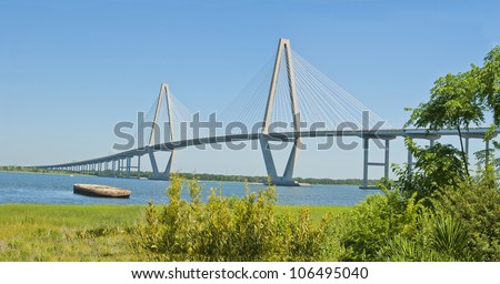The Port of Charleston, a cable stayed bridge, an abandoned barge, and the Cooper River in Charleston, South Carolina.