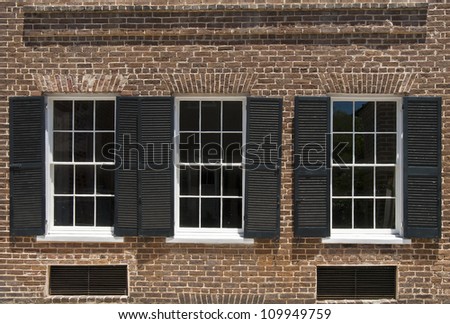 Windows and brick work of a townhouse built in the nineteenth century.