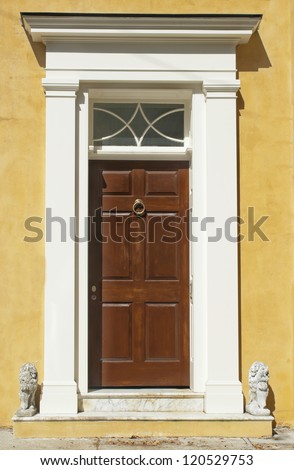 The front door and decorative lions of a Victorian Era house.