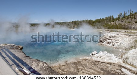 The crystal blue steaming waters of the Excelsior Geyser pool at Midway Geyser Basin in Yellowstone National Park.