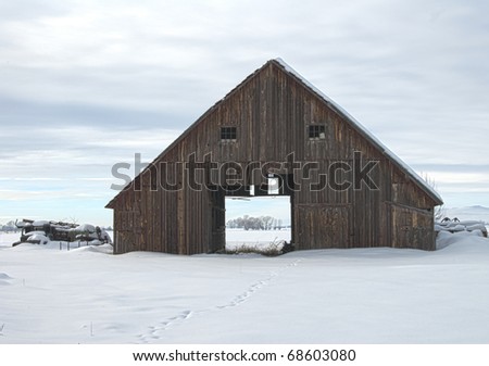 An old barn weathers in the cold winter.