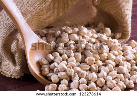 Chickpeas in a wooden spoon and bag