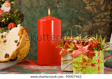 Christmas candle, gifts and panettone (traditional Christmas\' italian cake)