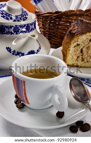 A cup of espresso coffee and a piece of cake for a perfect italian breakfast