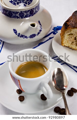 A cup of espresso coffee and a piece of cake for a perfect breakfast