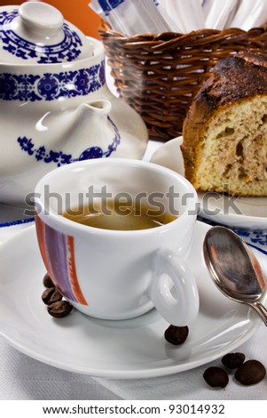 An hot smoking espresso coffee and a piece of cake for a perfect italian breakfast