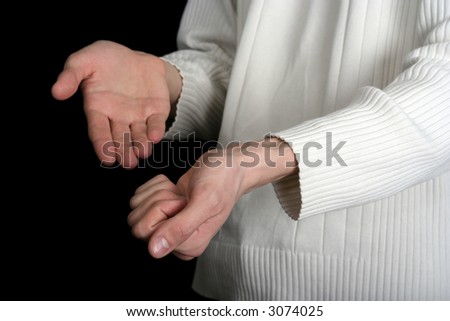 one male hand holding something, other point at it