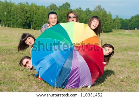 Big group of young girls and a big umbrella