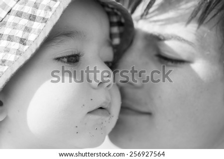 Mother kissing her baby, close up portraits