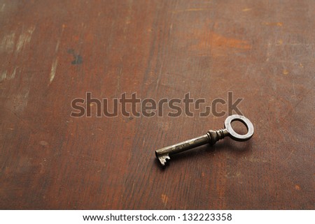 Vintage key on the wooden surface