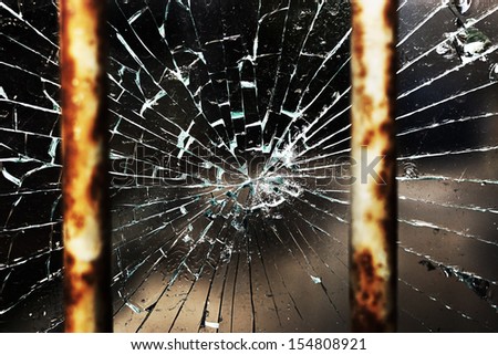 Cracked glass behind bars