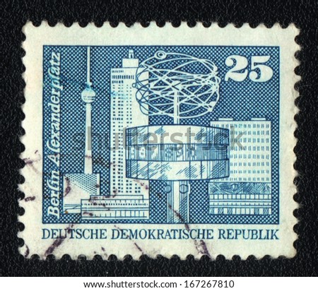 DDR - CIRCA 1974: A stamp printed in DDR  shows World clock, Alexander Square in Berlin, circa 1974
