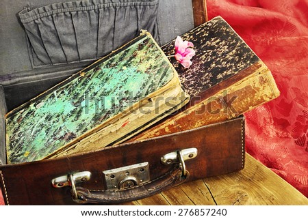 The old book in a vintage leather suitcase