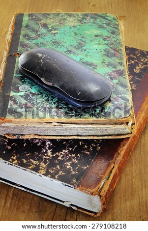 Metallic spectacle-case on old books