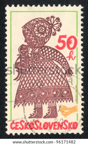 CZECHOSLOVAKIA - CIRCA 1980: A stamp printed in CZECHOSLOVAKIA  shows Folk baby with doll, from series, circa 1980