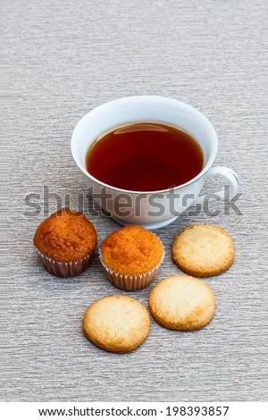 Cup cake, cookie and a cup of tea