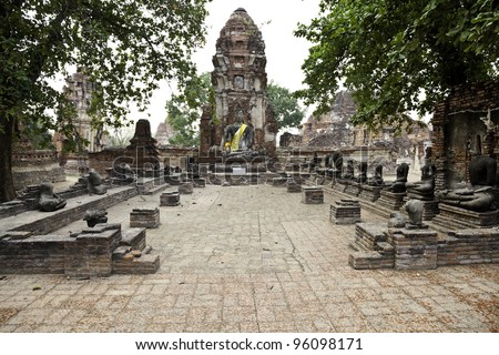 seated buddha statue and the ruins at way mahathat in ancient city of ayutthaya, thailand